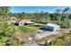 Aerial view of single-Gathering home, storage shed and large manicured lot, showcasing the property's curb appeal at 4101 Poinciana Dr, Indian Lake Estates, FL 33855