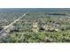 Aerial view of a home in a wooded area with surrounding trees and vegetation at 4101 Poinciana Dr, Indian Lake Estates, FL 33855