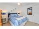 Cozy bedroom with blue and white bedding, complemented by a matching mirror and side tables for a serene retreat at 4101 Poinciana Dr, Indian Lake Estates, FL 33855