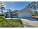 Charming single-story home with a manicured front lawn, featuring a two-car garage and walkway to the front door at 4101 Poinciana Dr, Indian Lake Estates, FL 33855