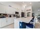 Modern white kitchen with stainless steel appliances and a large quartz countertop island at 4101 Poinciana Dr, Indian Lake Estates, FL 33855