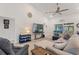 Bright living room featuring a ceiling fan, neutral paint, and a sliding door to the patio at 4101 Poinciana Dr, Indian Lake Estates, FL 33855