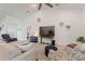 Cozy living room featuring a ceiling fan, comfortable seating, and wall art at 4101 Poinciana Dr, Indian Lake Estates, FL 33855