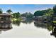 Waterfront view of multiple docks and boathouses extending into the lake at 4101 Poinciana Dr, Indian Lake Estates, FL 33855