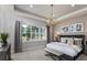 Serene main bedroom with a large window, elegant lighting, and stylish decor at 5243 Sw 88Th Cir, Ocala, FL 34481