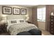 A nicely appointed main bedroom featuring a decorative padded headboard, decorative pillows and bedside tables at 5896 Meditation Dr, Clermont, FL 34714