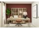 Stylish home office with a neutral desk, orange chair, storage cabinet, modern decor, and a burgundy accent wall at 954 Hour Glass Rd, Lakeland, FL 33801