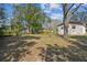 Expansive backyard with large trees providing shade and a detached home in the background at 1422 Connestee Rd, Lakeland, FL 33805