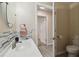 Well-lit bathroom featuring stylish decor, modern fixtures, a tiled backsplash, and a view into the hallway at 1422 Connestee Rd, Lakeland, FL 33805