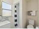 Bright bathroom features a window for natural light and black and white striped shower curtain at 1422 Connestee Rd, Lakeland, FL 33805