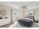 Serene bedroom with a calming color scheme, a decorative ceiling fan, and well-lit windows at 1422 Connestee Rd, Lakeland, FL 33805