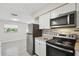 Modern kitchen with stainless steel appliances, stylish backsplash, and white cabinets providing ample storage space at 1422 Connestee Rd, Lakeland, FL 33805