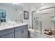 Bathroom featuring double sinks, modern fixtures, and a glass-enclosed shower at 2509 Penguin Blvd, Davenport, FL 33837