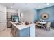 Modern kitchen featuring gray cabinets, stainless steel appliances, and a center island with barstool seating at 2509 Penguin Blvd, Davenport, FL 33837