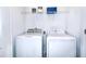 Functional laundry room with a washer, dryer, and wire shelving for storage at 2509 Penguin Blvd, Davenport, FL 33837