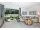 Bright and airy living room with neutral decor, modern artwork, and sliding glass doors to the patio at 2509 Penguin Blvd, Davenport, FL 33837