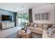 Inviting living room featuring a comfortable sectional sofa and sliding glass doors to the backyard at 2509 Penguin Blvd, Davenport, FL 33837