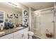 Bathroom featuring a glass enclosed shower, granite countertop, and framed mirrors at 2513 Penguin Blvd, Davenport, FL 33837