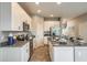 Bright kitchen featuring white cabinetry, stainless steel appliances, and granite countertops at 2513 Penguin Blvd, Davenport, FL 33837