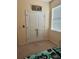 This bedroom is carpeted with a double door closet and a window to allow plenty of natural light at 3088 Pointe Place Ave, Kissimmee, FL 34758