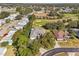 Aerial view of a home in a serene community near a golf course at 562 Dowling Cir, Lady Lake, FL 32159