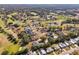 Panoramic aerial view of a golf course community with lush greenery and tranquil ponds at 562 Dowling Cir, Lady Lake, FL 32159