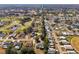 Residential neighborhood aerial view featuring golf course, mature trees, and well-maintained homes at 562 Dowling Cir, Lady Lake, FL 32159