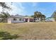 Spacious backyard with a screened lanai, perfect for outdoor relaxation at 562 Dowling Cir, Lady Lake, FL 32159