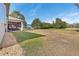 Expansive backyard featuring a screened lanai and lush greenery at 562 Dowling Cir, Lady Lake, FL 32159