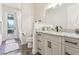 Well-lit bathroom featuring marble countertops, gray cabinetry, and a glass-enclosed shower at 562 Dowling Cir, Lady Lake, FL 32159