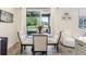 Bright dining area featuring a glass table, white chairs, and sliding glass doors to the outdoor space at 562 Dowling Cir, Lady Lake, FL 32159