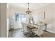 Elegant dining room with a modern chandelier, seating for six, and stylish decor at 562 Dowling Cir, Lady Lake, FL 32159