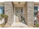 Charming entryway with stone accents, a welcoming door, and decorative plants at 562 Dowling Cir, Lady Lake, FL 32159