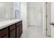 Bathroom with tiled floor, single sink, and glass shower door at 6973 Wilson Pasture Ave, Groveland, FL 34736