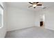 Spacious bedroom with light gray carpet, ceiling fan, and ensuite bathroom at 6973 Wilson Pasture Ave, Groveland, FL 34736