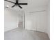 Bedroom featuring gray carpet, ceiling fan, and closet at 6973 Wilson Pasture Ave, Groveland, FL 34736