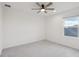 Bright bedroom featuring a ceiling fan, carpeted floor, and a window providing natural light at 6973 Wilson Pasture Ave, Groveland, FL 34736