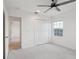 Cozy bedroom featuring plush carpeting, a ceiling fan, and a closet for ample storage at 6973 Wilson Pasture Ave, Groveland, FL 34736