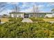 Clubhouse featuring modern architecture with stone accents, lush landscaping, and inviting entryway at 6973 Wilson Pasture Ave, Groveland, FL 34736