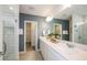 Modern bathroom featuring double vanity sinks, a large mirror, and a glass-enclosed shower with tiled walls at 8291 Sw 54Th Loop, Ocala, FL 34481