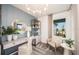 Cozy home office featuring a desk, chair, shelving, and natural light from a large window, creating a workspace at 8291 Sw 54Th Loop, Ocala, FL 34481