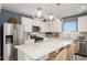 Modern kitchen featuring white cabinets, stainless steel appliances, pendant lighting, and a large island with seating at 8291 Sw 54Th Loop, Ocala, FL 34481