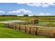 Picturesque water feature with a gazebo on a pier overlooking a lush green landscape under a blue sky at 8291 Sw 54Th Loop, Ocala, FL 34481