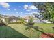 Manicured backyard with lush green grass and meticulously maintained landscaping at 1713 Altavista Cir, Lakeland, FL 33810