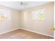 This bedroom features neutral paint, tile flooring, and natural light from the two bright windows at 6317 Georgia Ave, Lakeland, FL 33813