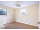 This bedroom features neutral paint, tile flooring, and natural light from the two bright windows at 6317 Georgia Ave, Lakeland, FL 33813