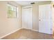 This bedroom features neutral paint, tile flooring, closet, and natural light from the bright window at 6317 Georgia Ave, Lakeland, FL 33813