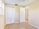 This bedroom features neutral paint, tile flooring, closet, and natural light from the bright window at 6317 Georgia Ave, Lakeland, FL 33813