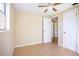 This bedroom features neutral paint, tile flooring, a ceiling fan, and natural light from the window at 6317 Georgia Ave, Lakeland, FL 33813