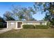 Well-maintained single-story home with green bushes in the front, enhancing the property's curb appeal at 6317 Georgia Ave, Lakeland, FL 33813